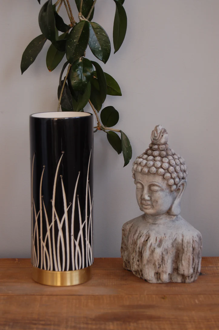 Decorative vase and Buddha statue on table