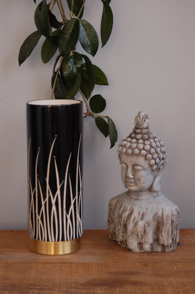 Decorative vase and Buddha with green leaves