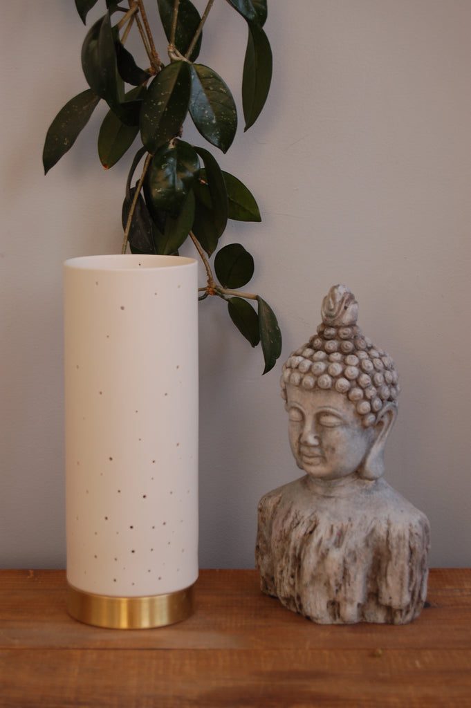 Ceramic vase beside Buddha statue