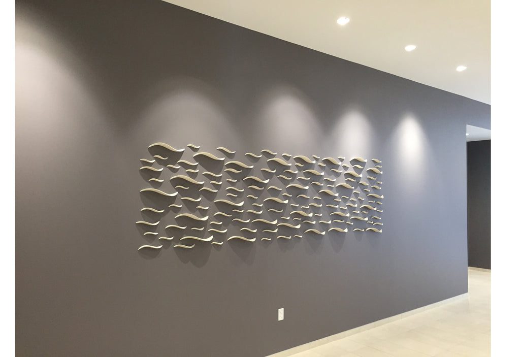 Contemporary metal art on gray wall