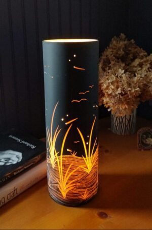 Artistic lamp beside dried flowers