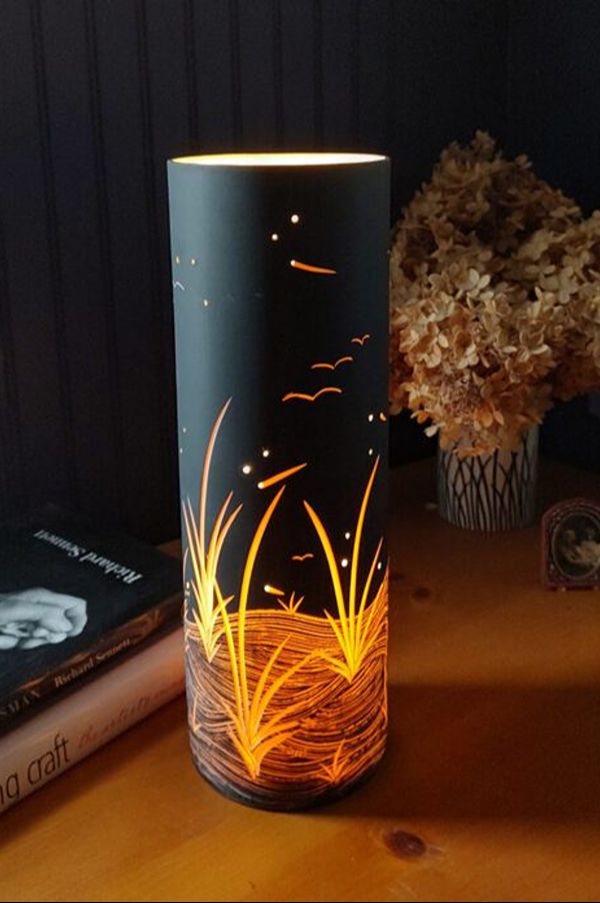 Artistic lamp beside dried flowers