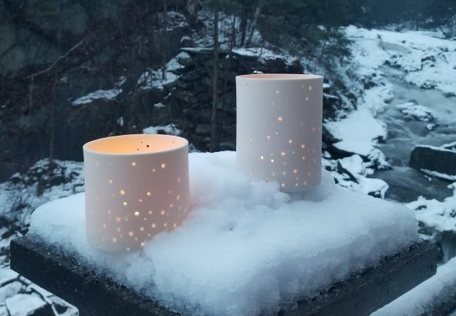 Candles glowing in snowy landscape
