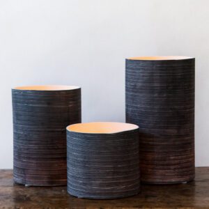 Trio of decorative vases with ribbed design.