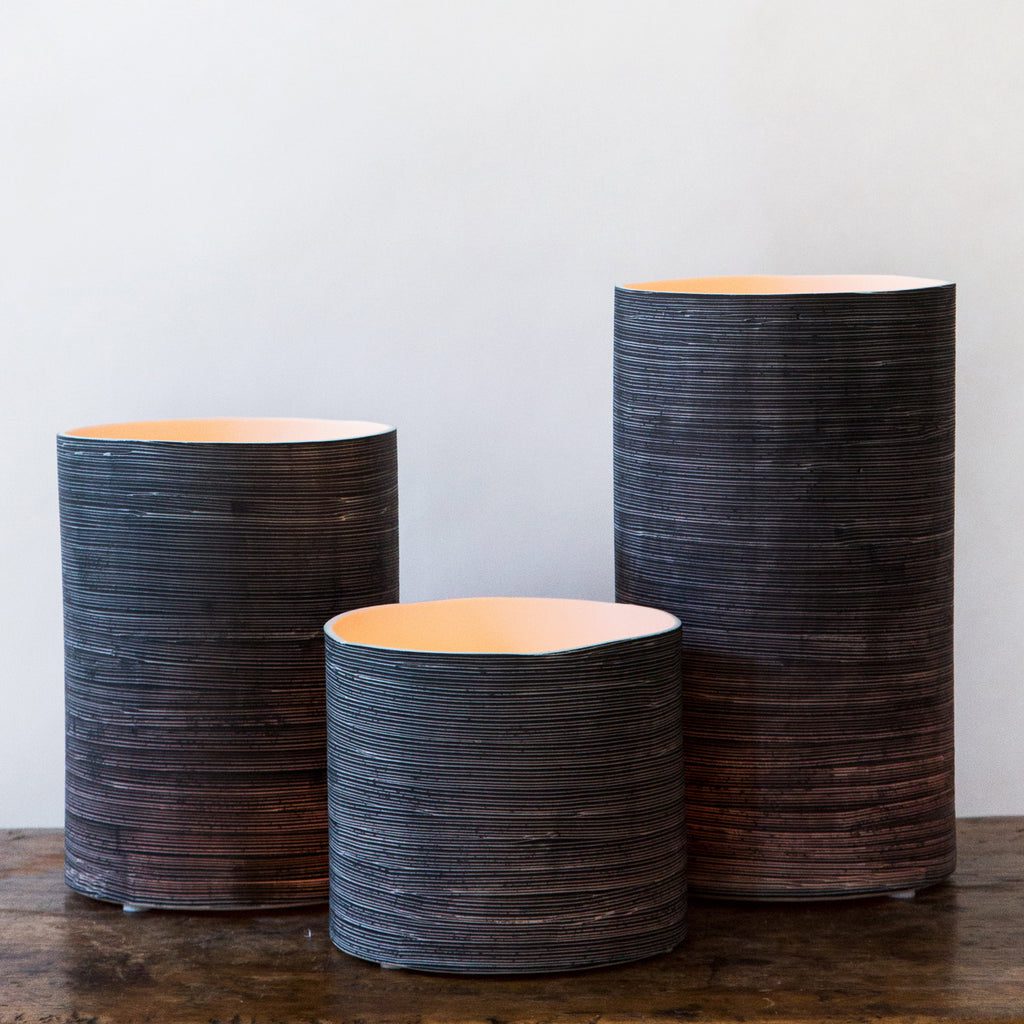 Trio of decorative vases with ribbed design.