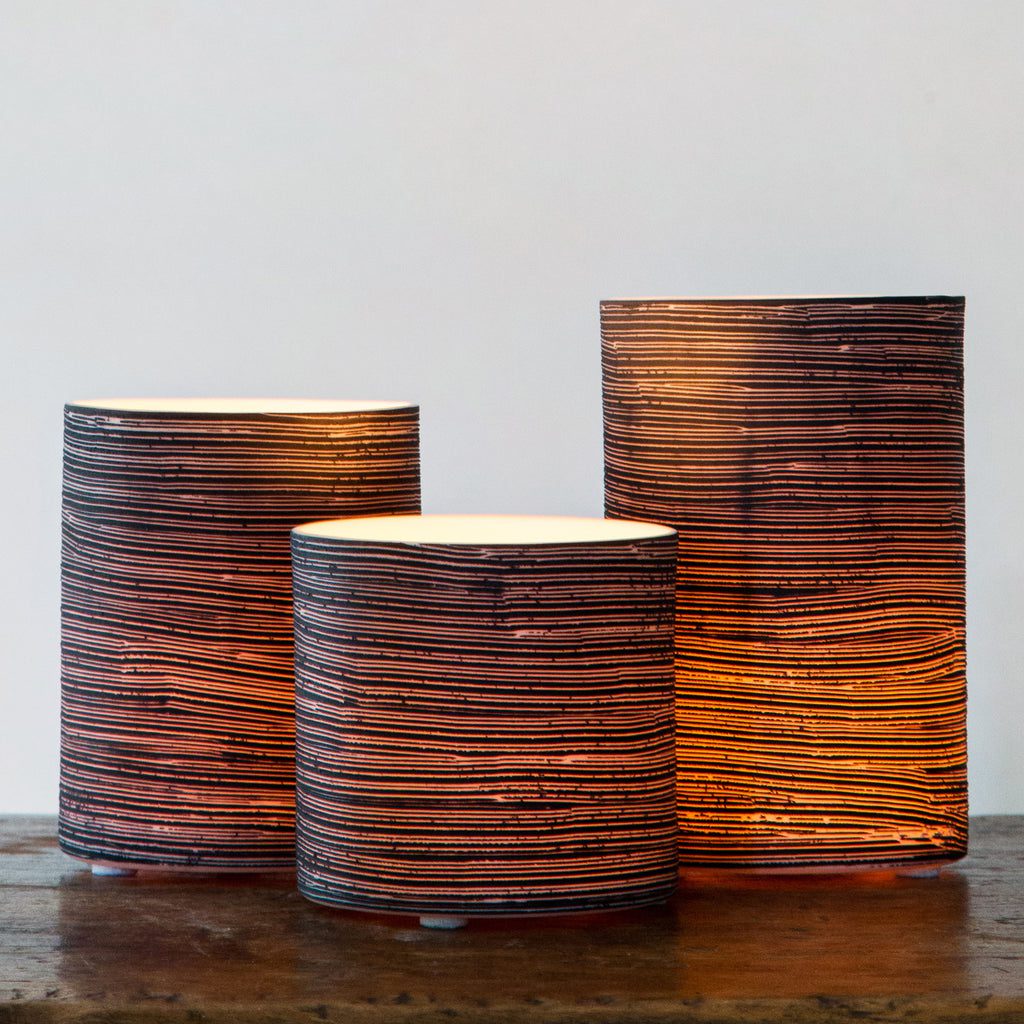 Warm ambient light from three table lamps.