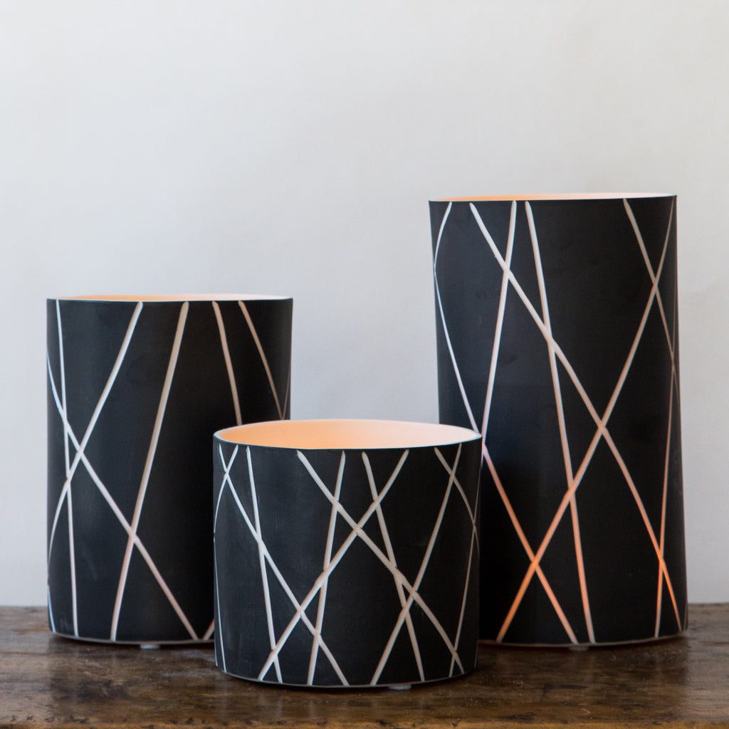 Geometric black vases with white lines