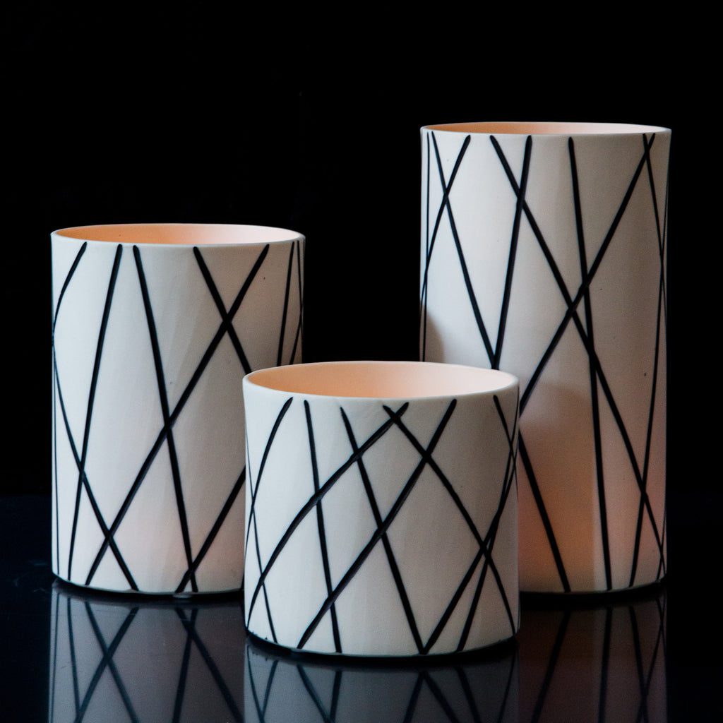 Modern cylindrical vases on black background