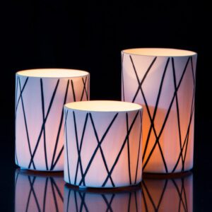 Illuminated candles with geometric designs