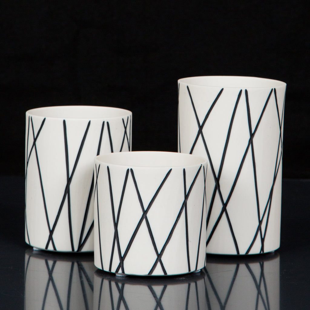 Trio of white vases with lines
