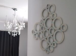 Wall art and chandelier in modern room