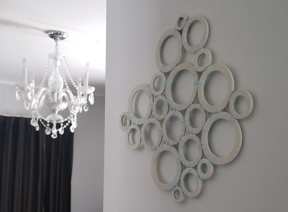 Wall art and chandelier in modern room