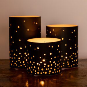 Decorative candle holders with starry cutouts