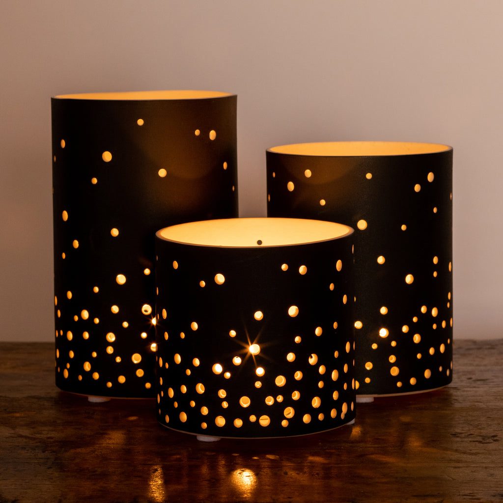 Decorative candle holders with starry cutouts