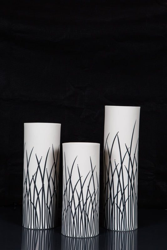 Tall white vases with black grass patterns