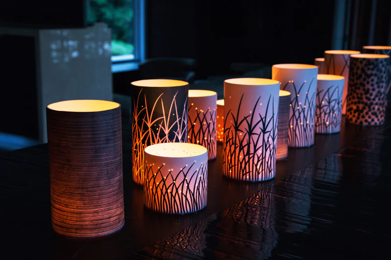 Glowing decorative candle holders on table