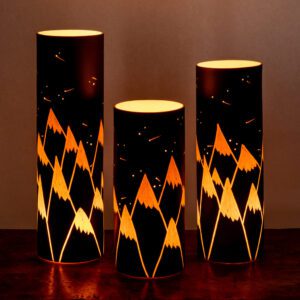 Glowing mountain-themed cylindrical lamps