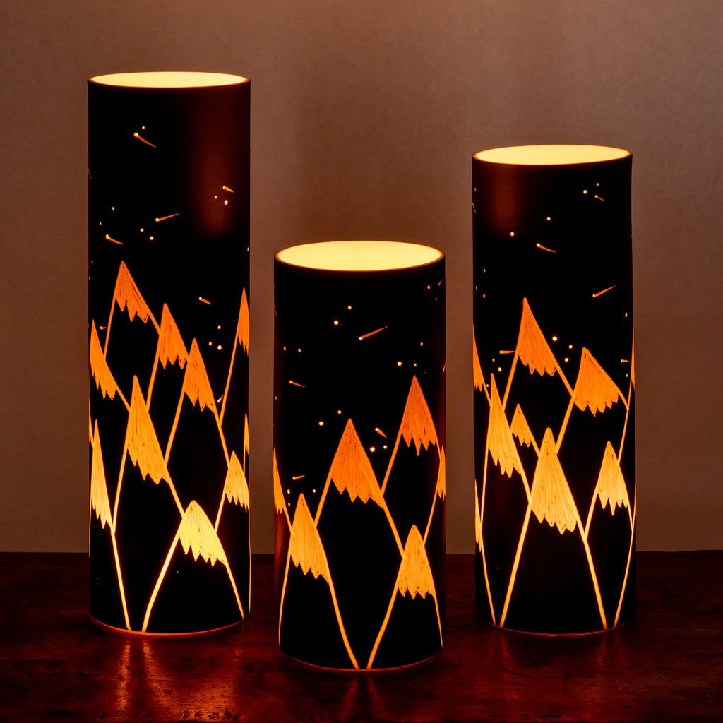 Glowing mountain-themed cylindrical lamps