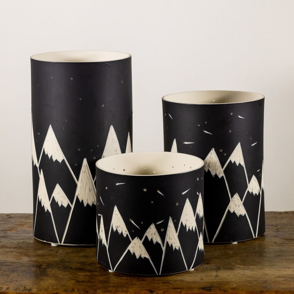 Three decorative mountain-themed vases