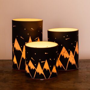 Mountain-patterned lamps on wooden surface