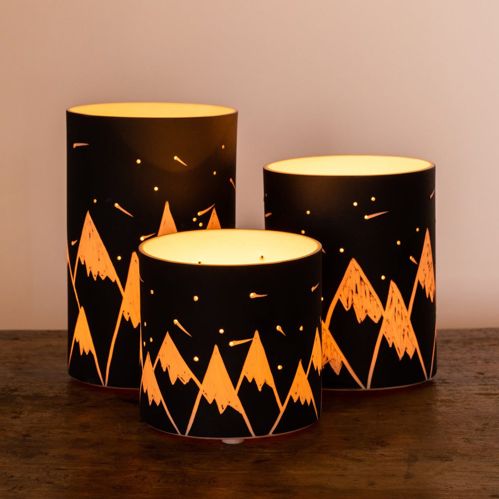Mountain-patterned lamps on wooden surface