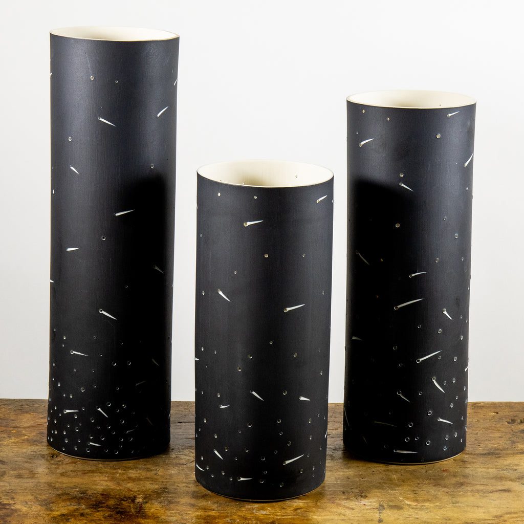 Tall black vases with speckled pattern