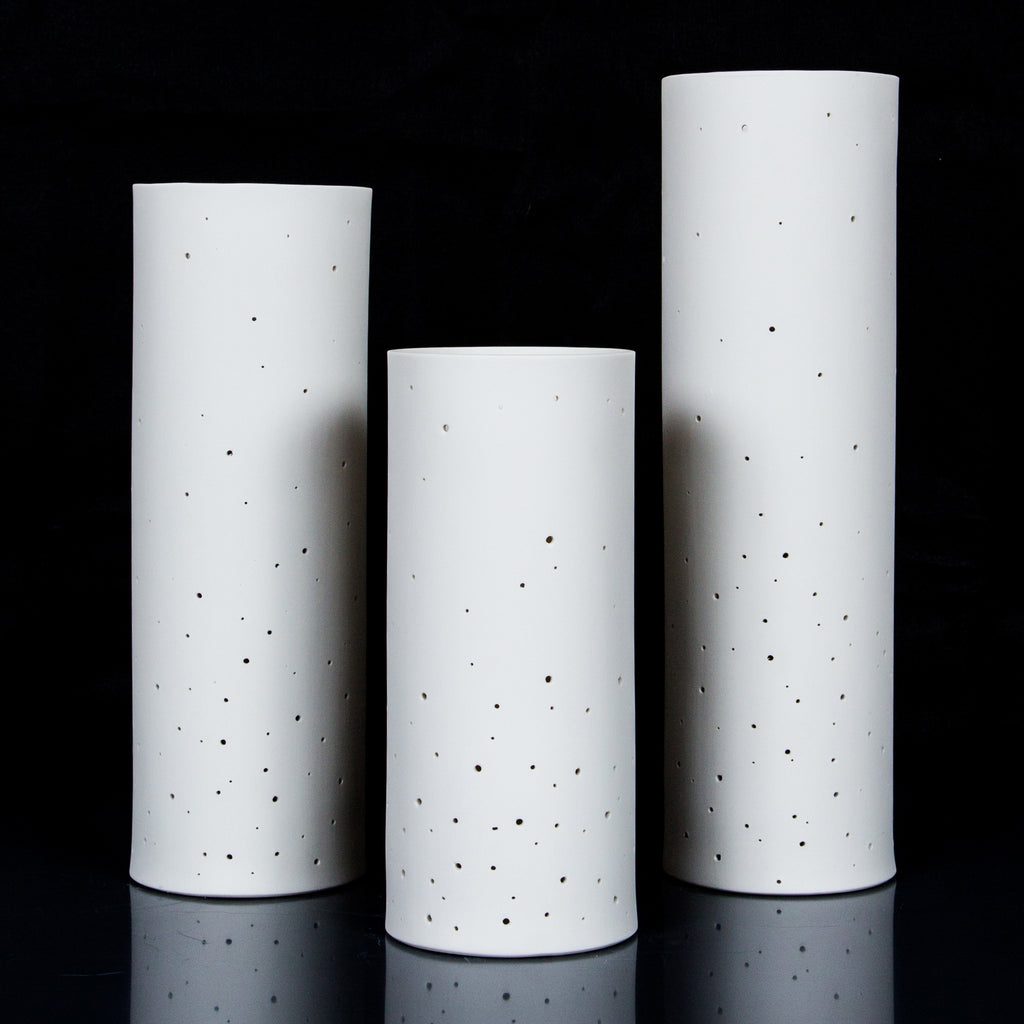 Three ceramic lanterns against black background