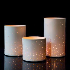 Decorative candle holders with glowing holes
