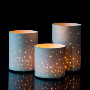 Three lit lanterns against dark background