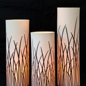 Three cylindrical lamps with glowing patterns