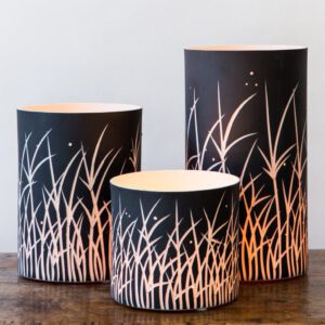 Elegant cylindrical lamps on wooden table