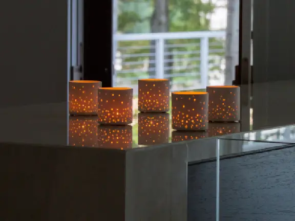 Warm candlelight on a reflective table