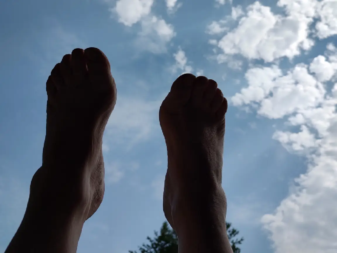 Relaxing view of feet and clouds