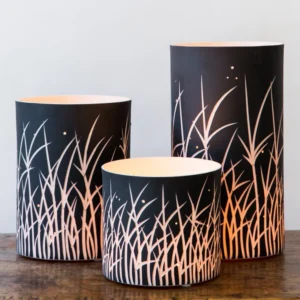Three cylindrical lamps on wooden surface